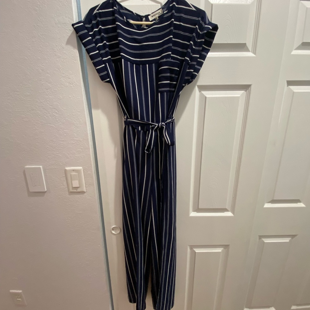 New. Never worn. Navy blue w/ white strips Jumpsuit with legs flares